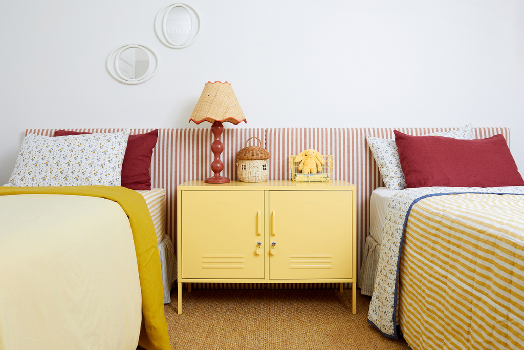 a kids room featuring a butter locker with red accessories