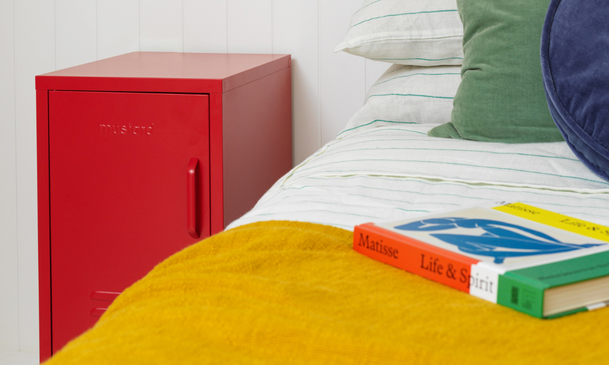 A Shorty to the Left Poppy Locker beside a bed.