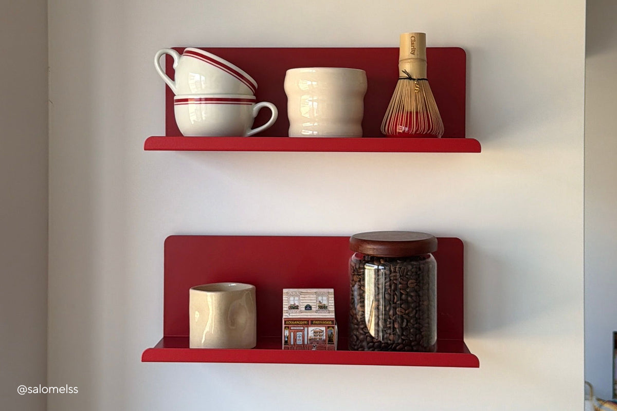 A pair of The Ledge floating shelves in Poppy red, styled as a coffee station with cups, a matcha whisk and a jar of coffee beans