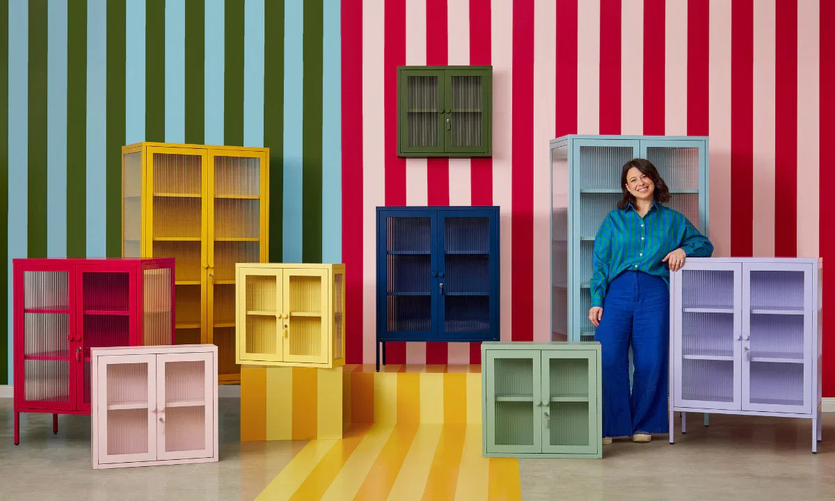 Co-Founder, Becca Stern standing with The Glass Collection by Mustard Made