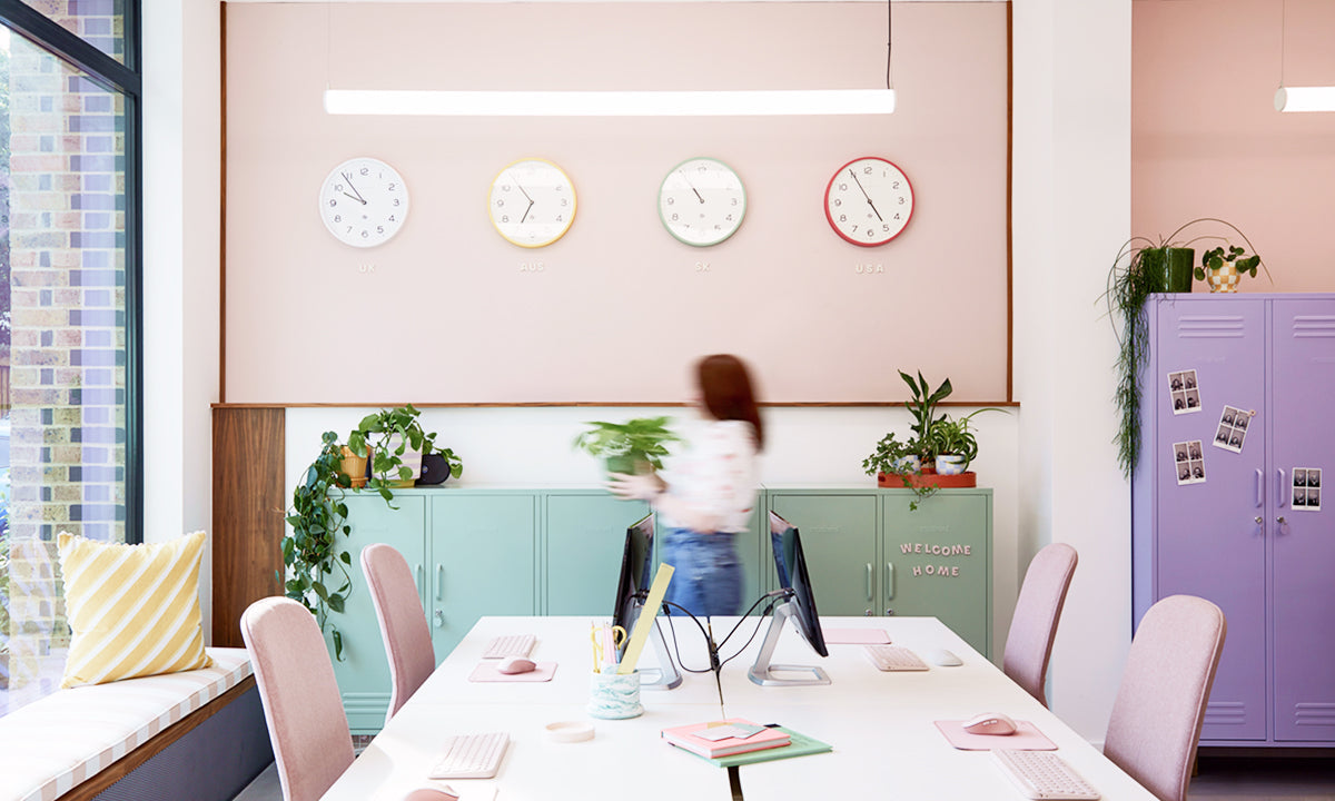 The Midi locker in Sage green and The Twinny in Lilac purple in Mustard Made's pastel UK office with wall clocks