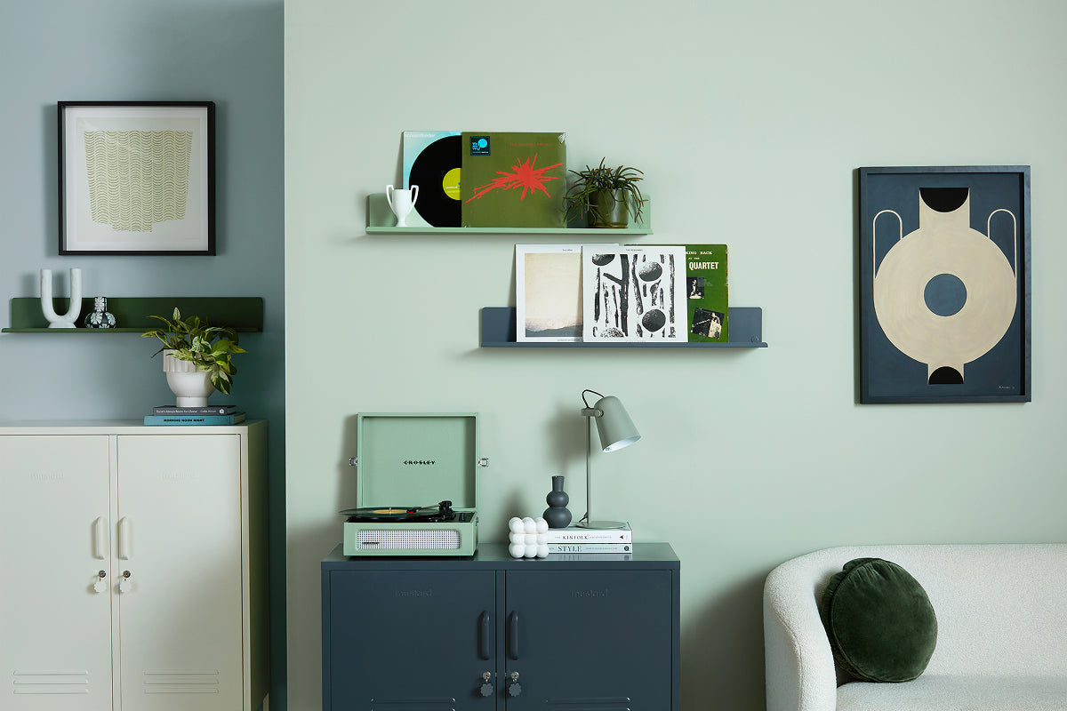 The Midi locker in Navy blue with a turntable, plus The Ledge shelves in Sage green and Navy displaying vinyl records