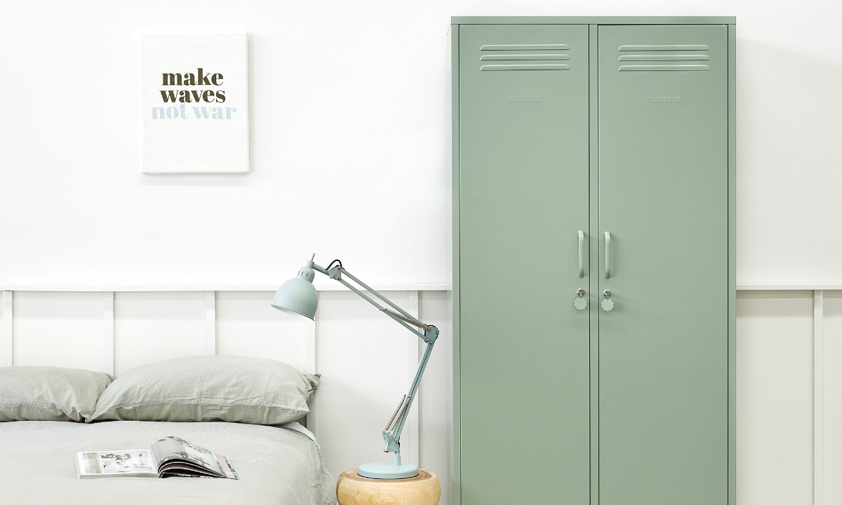 The Twinny in Sage next to a bed.