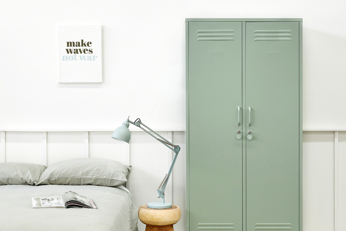 The Twinny in Sage next to a bed.