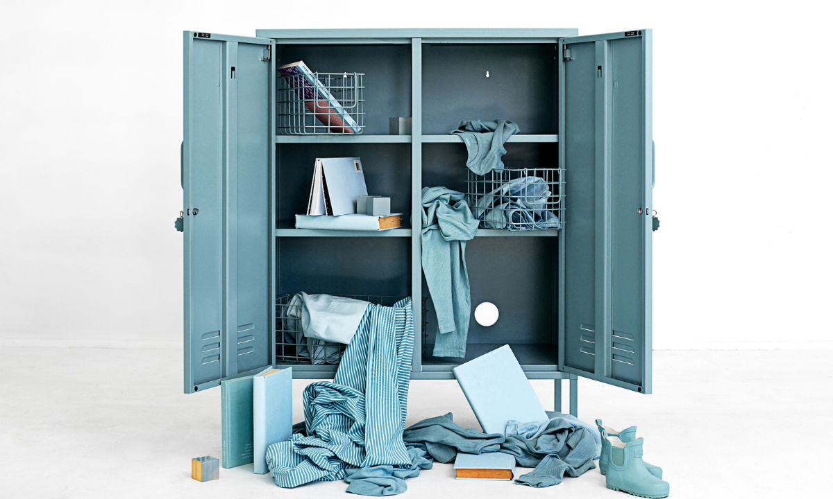 An Ocean Midi locker has both doors open to reveal a mess of Ocean coloured belongings spilling out on to the floor.