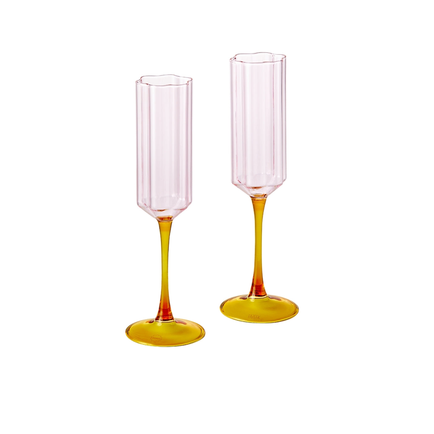 Two tall, thin glasses with pink top and yellow bottom on a white background